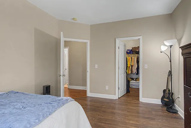 a bedroom with a bed and a mirror