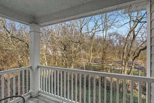 a view of a balcony with wooden fence