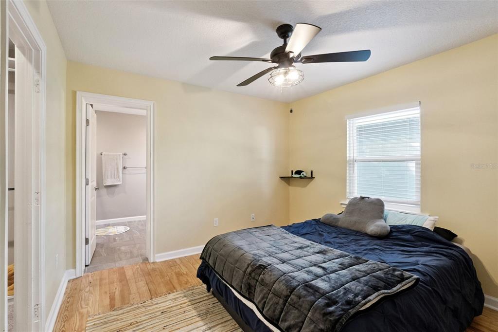 1304 Perkins Road Orlando, FL 32809 - Photo 11 of 22 a bedroom with a bed and wooden floor