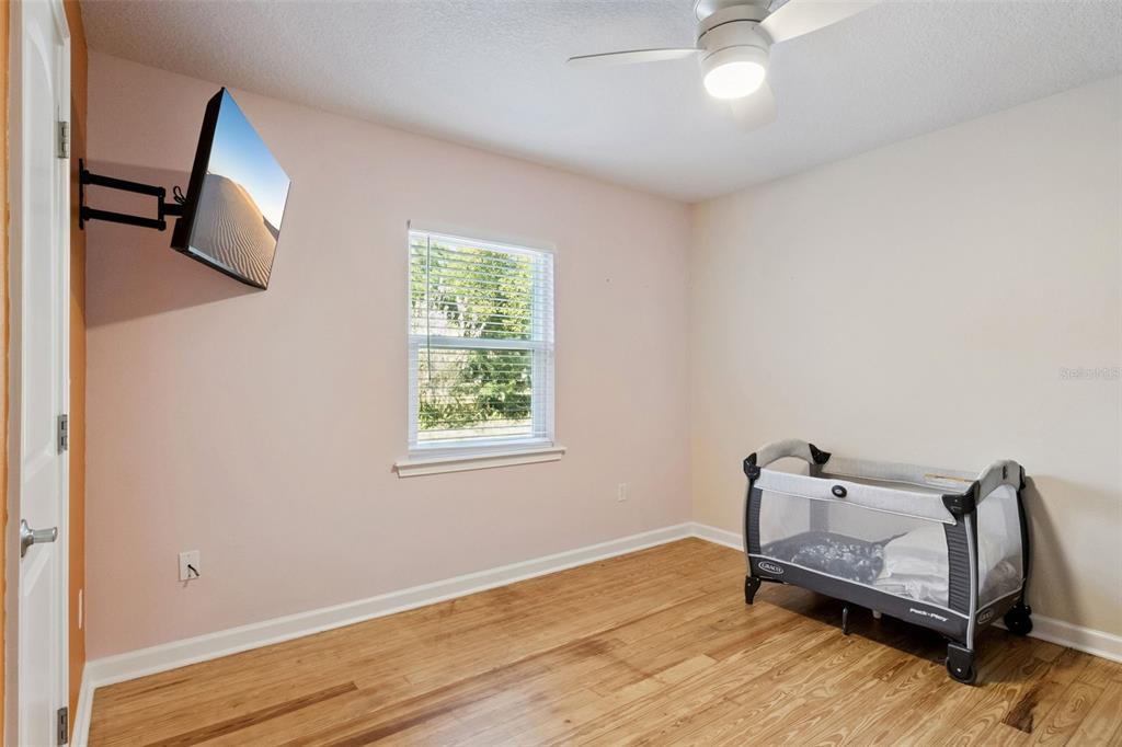 1304 Perkins Road Orlando, FL 32809 - Photo 13 of 22 a bedroom with a bed and wooden floor