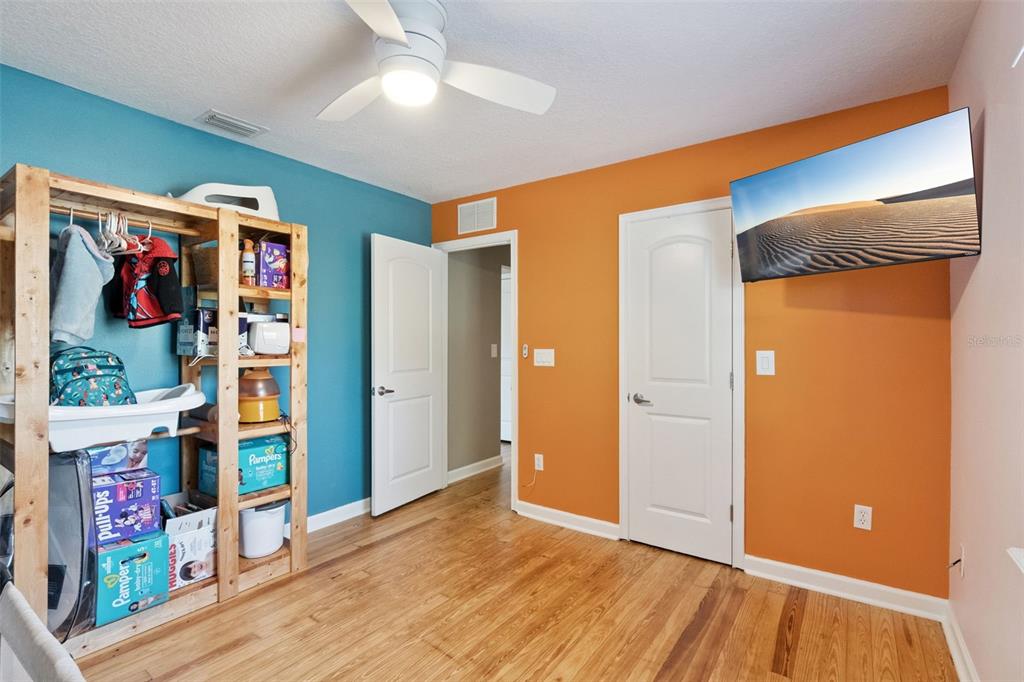1304 Perkins Road Orlando, FL 32809 - Photo 14 of 22 wooden floor in an empty room with a window