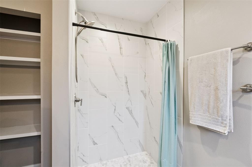 1304 Perkins Road Orlando, FL 32809 - Photo 17 of 22 a bathroom with a shower and a glass door