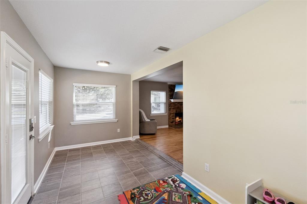 1304 Perkins Road Orlando, FL 32809 - Photo 3 of 22 a view of a hallway with wooden floor and a living room