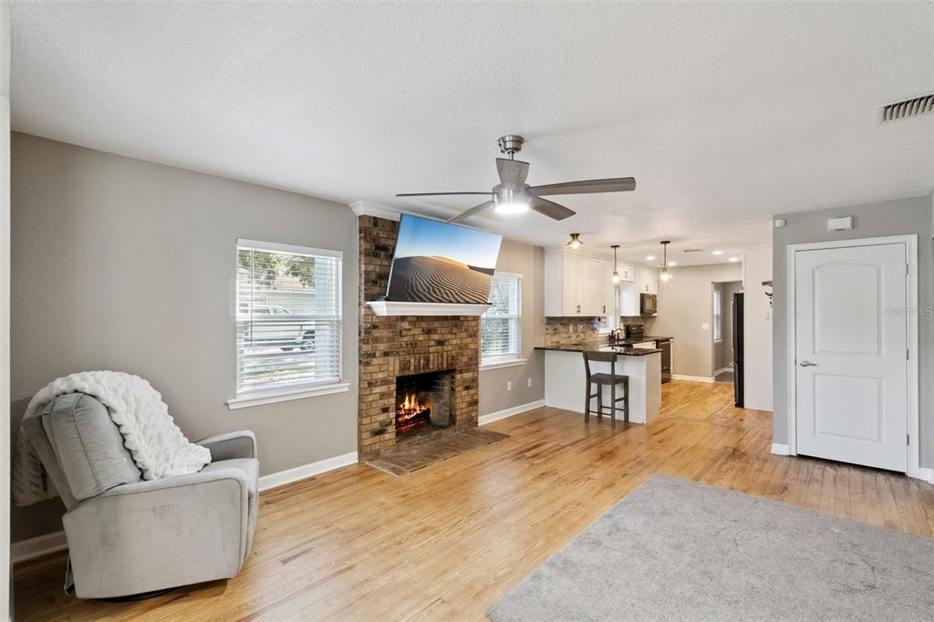 1304 Perkins Road Orlando, FL 32809 - Photo 6 of 22 a living room with furniture and a fireplace