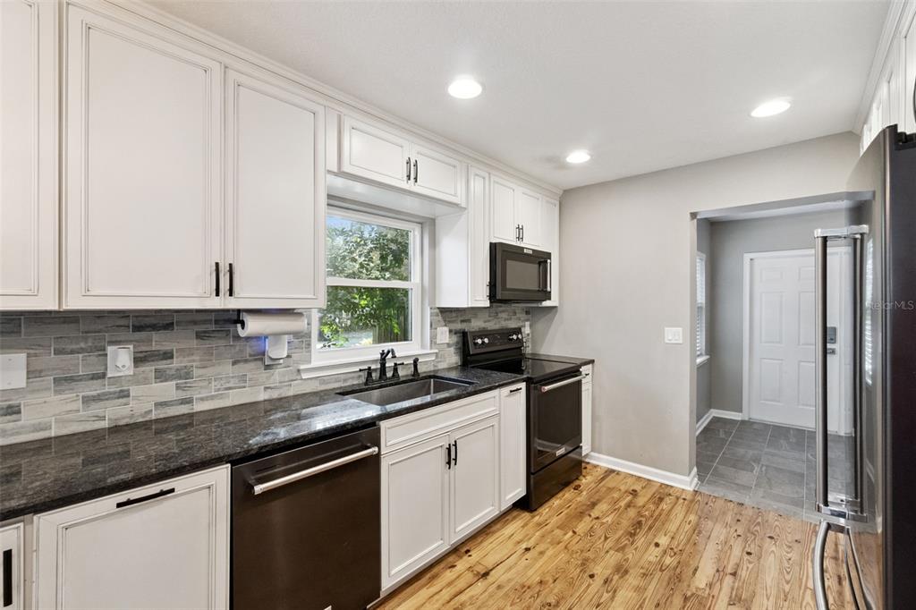 1304 Perkins Road Orlando, FL 32809 - Photo 9 of 22 a kitchen with a sink stove and microwave