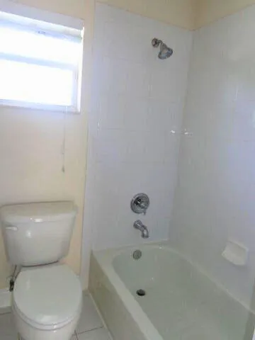 a kitchen with wooden floors and white cabinets