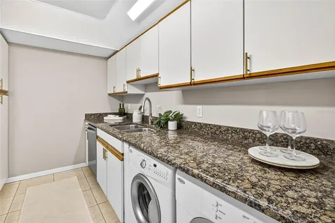 a kitchen with stainless steel appliances granite countertop a stove a microwave and a sink