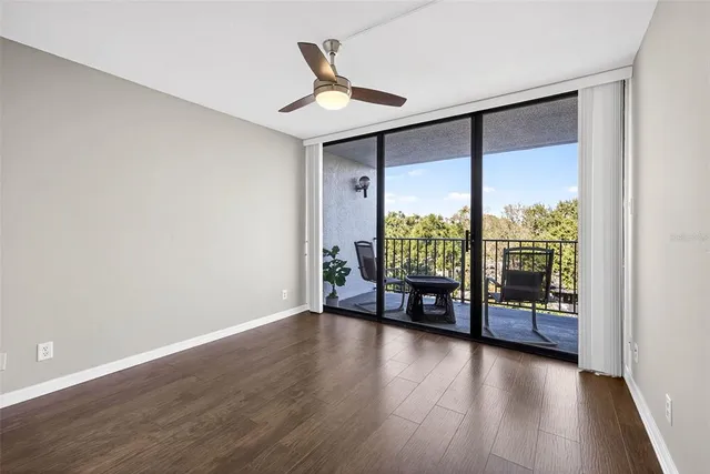 a bedroom with a large bed and a large window with the outer view