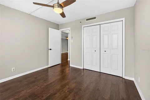 a bathroom with a granite countertop sink toilet mirror and shower