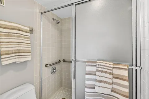 a kitchen with a white cabinets and chairs