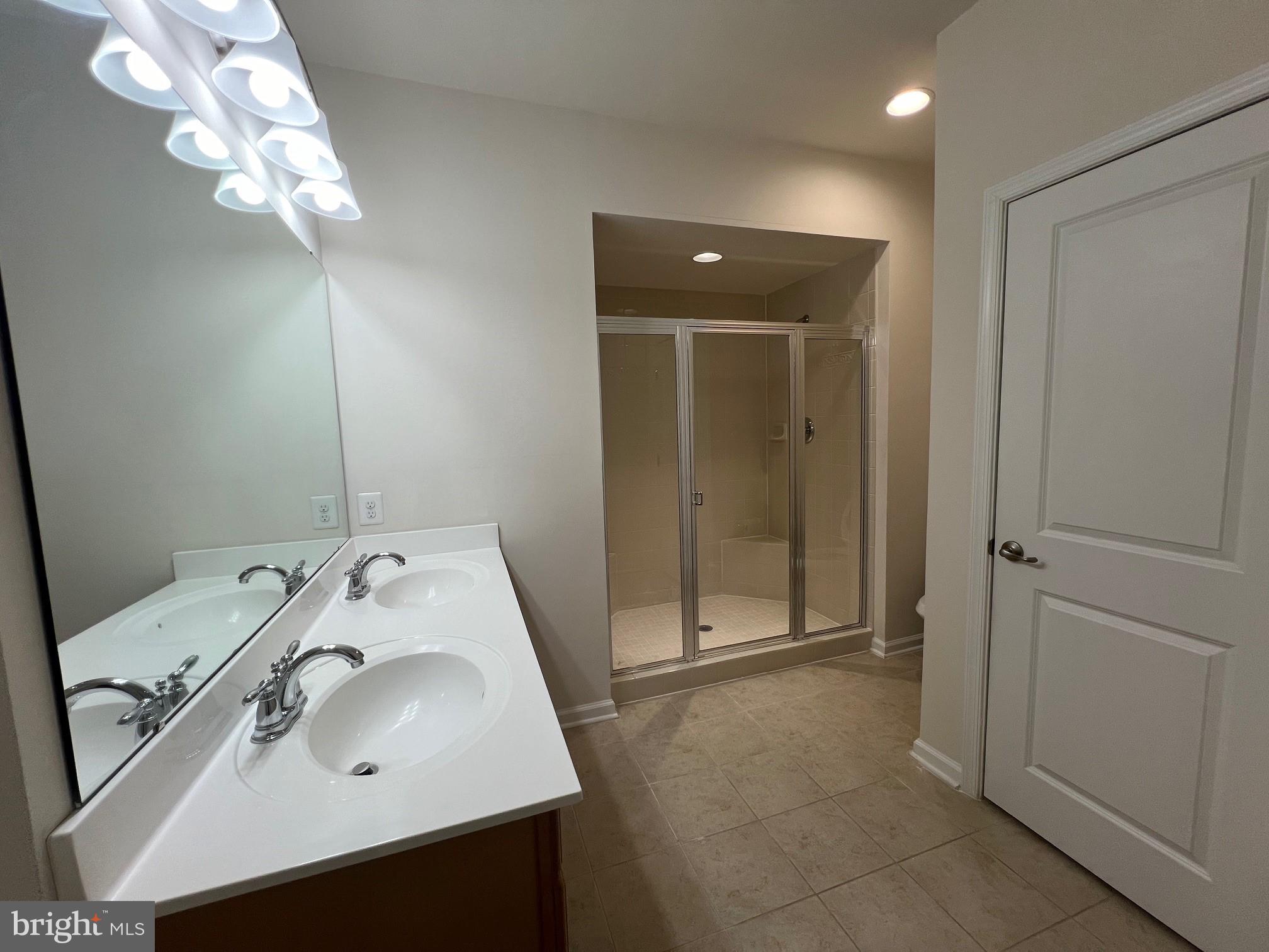 5057 Small Gains Way Frederick, MD 21703 - Photo 12 of 22 a bathroom with a sink a vanity and a mirror