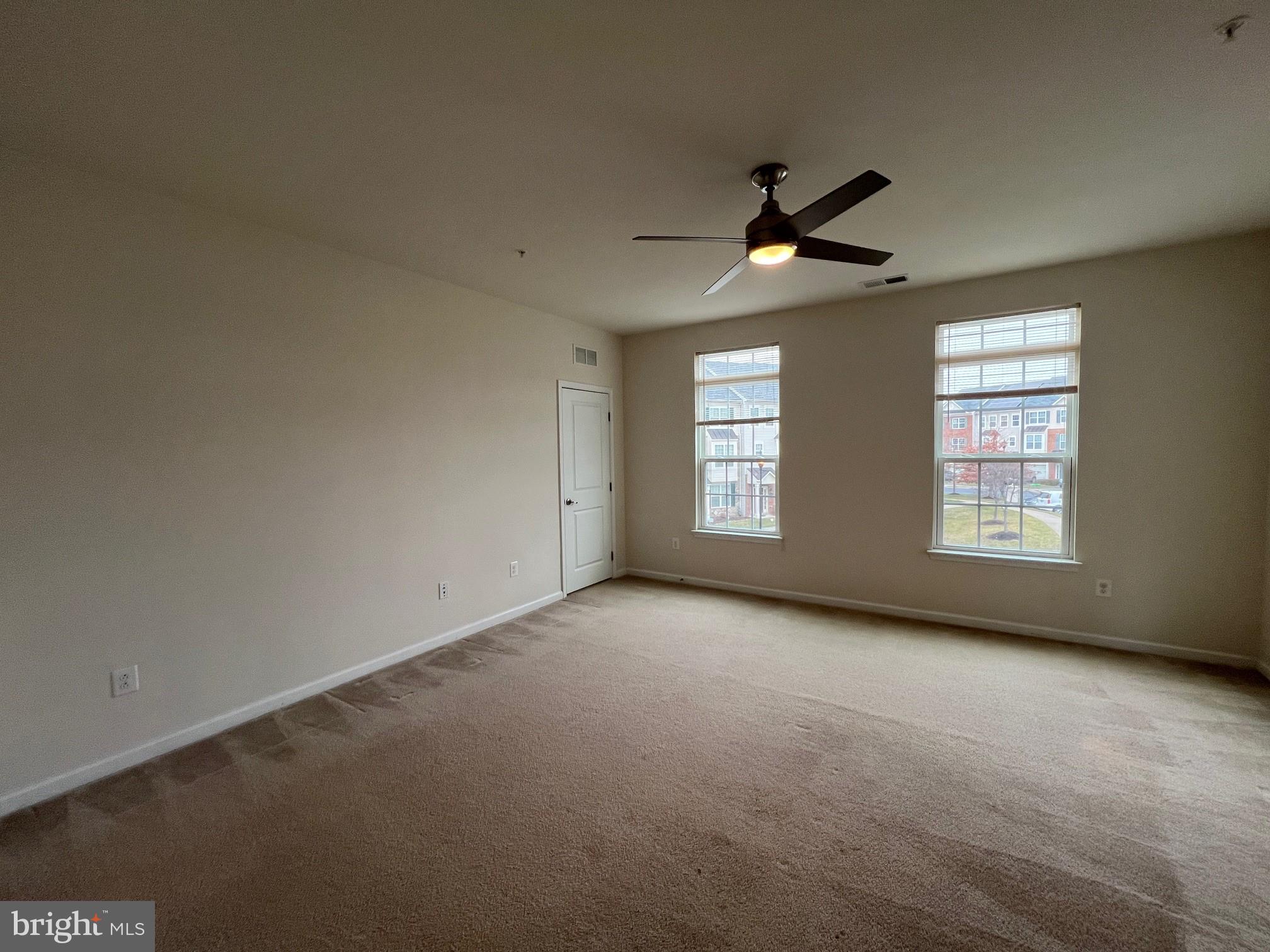5057 Small Gains Way Frederick, MD 21703 - Photo 10 of 22 an empty room with windows and fan
