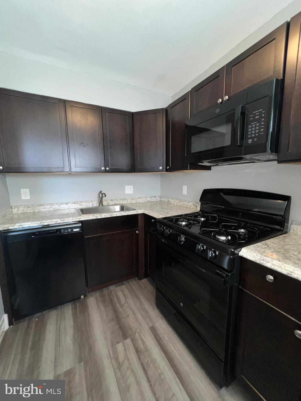 1128 Gleneagle Road Baltimore, MD 21239 - Photo 5 of 21 a kitchen with stainless steel appliances granite countertop a stove a sink and a microwave
