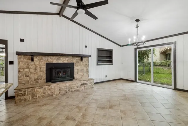a view of empty room with fireplace and fan
