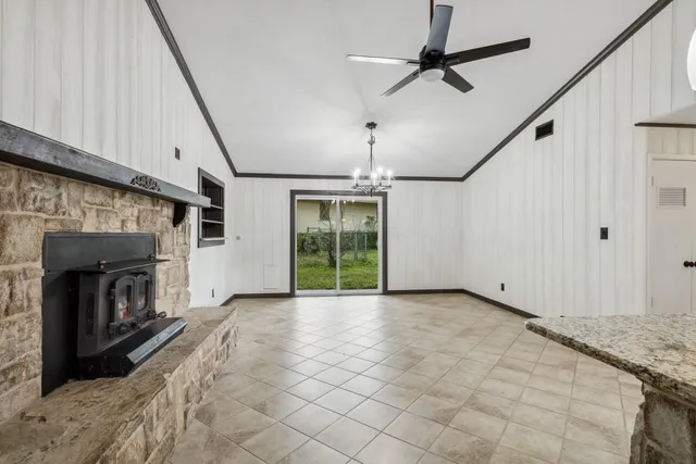 a view of empty room with fireplace and fan