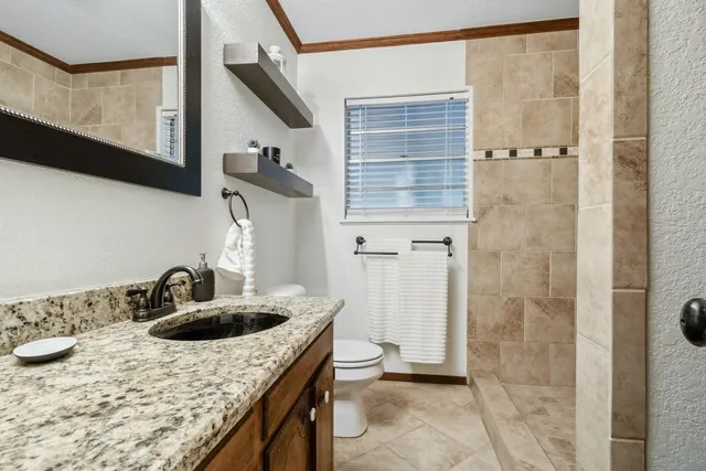 a kitchen with a sink a refrigerator and cabinets