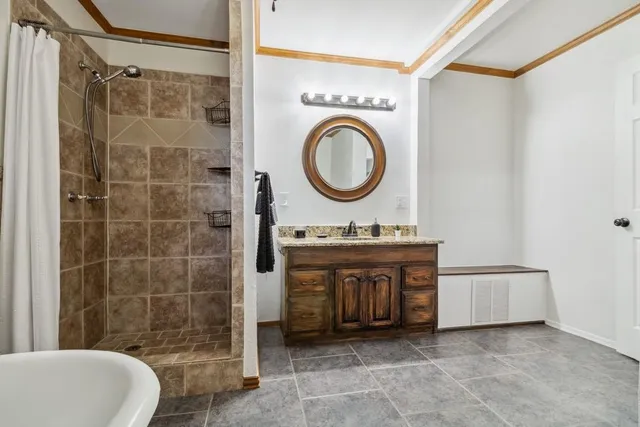 a bathroom with a sink a toilet and a shower