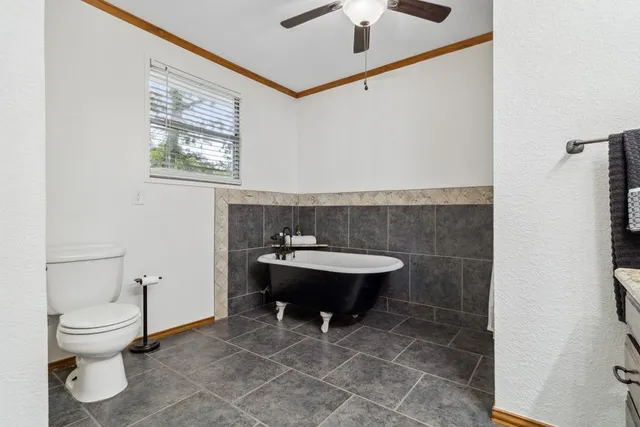 a bathroom with a toilet a sink and a mirror