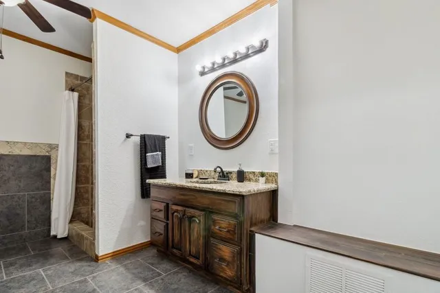 a bathroom with a sink a vanity and a mirror
