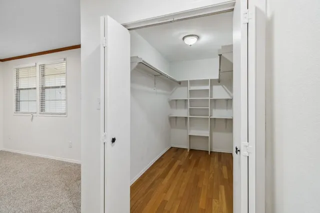 a view of a room with wooden floor and closet