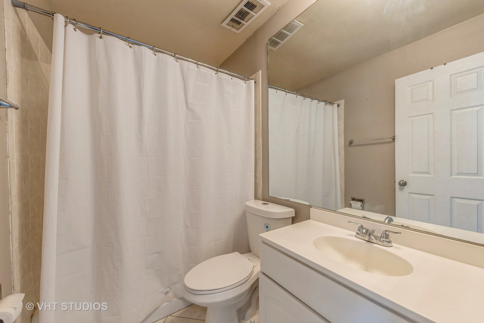 1400 North Elmhurst Road, Unit 219 Mount Prospect, IL 60056 - Photo 7 of 10 a bathroom with a sink a toilet and a mirror