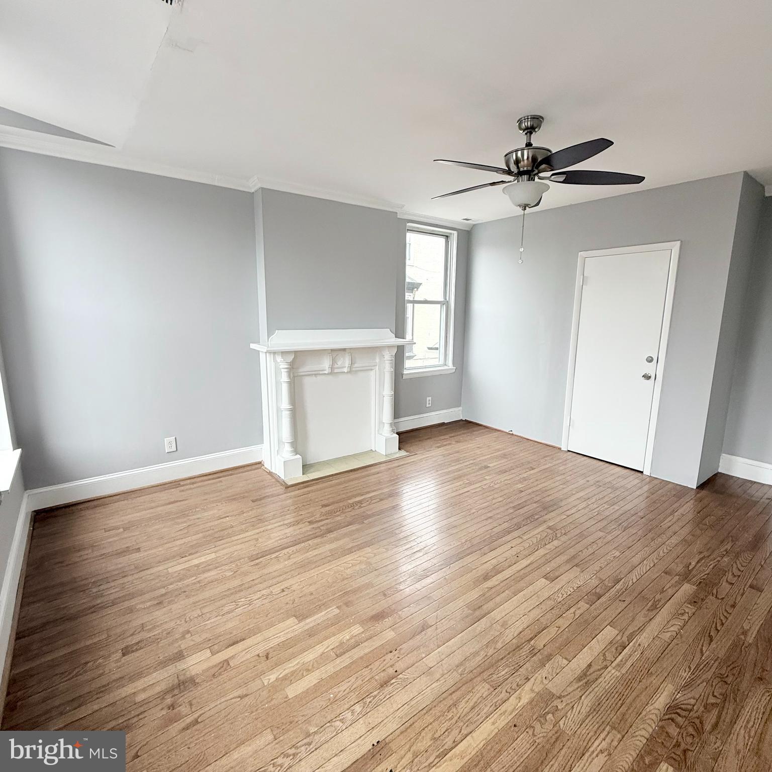 1001 Light Street, Unit 2 Baltimore, MD 21230 - Photo 4 of 11 a view of a livingroom with wooden floor and a ceiling fan