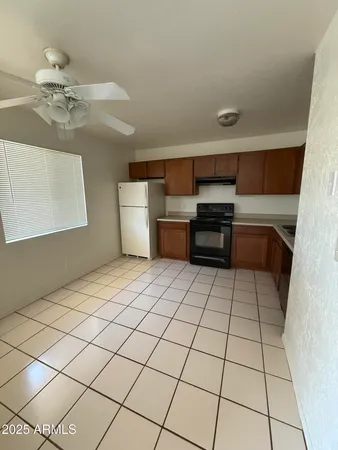 a room with washing machine and cabinets