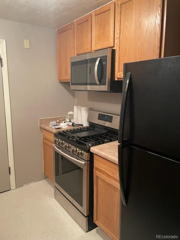 8246 Manitou Springs Road Blanca, CO 81123 - Photo 17 of 24 a kitchen with a stove microwave and refrigerator