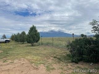 8246 Manitou Springs Road Blanca, CO 81123 - Photo 2 of 24 a view of a field with an trees around