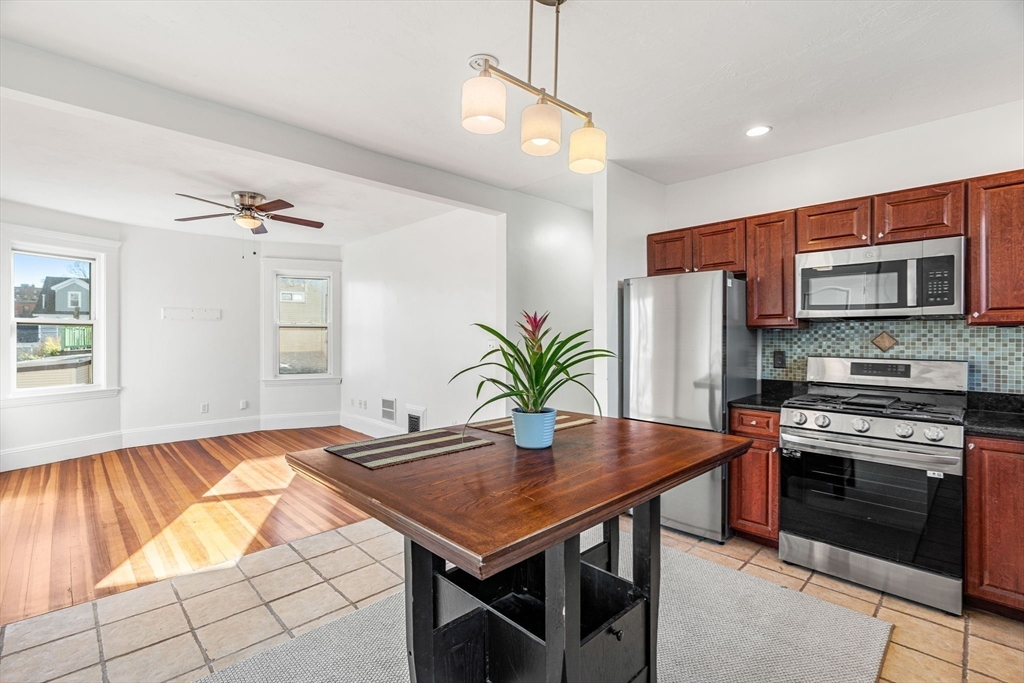 372 Adams Street, Unit 2 Boston, MA 02122 - Photo 11 of 20 a kitchen with a table and chairs in it