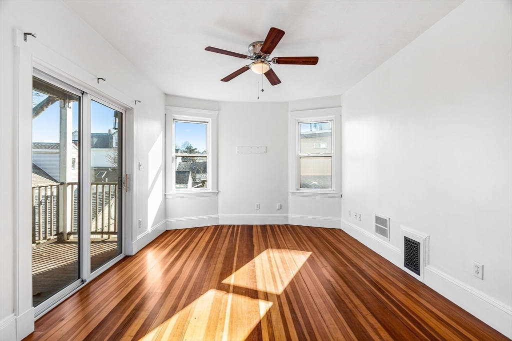 372 Adams Street, Unit 2 Boston, MA 02122 - Photo 15 of 20 a view of empty room with wooden floor and fan