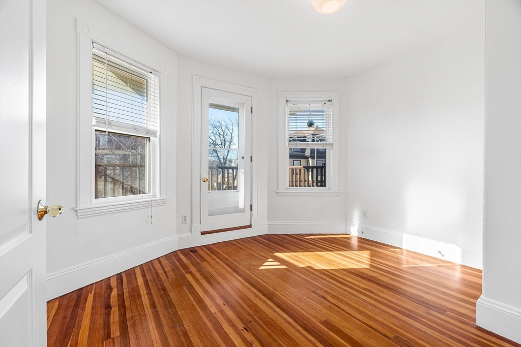 372 Adams Street, Unit 2 Boston, MA 02122 - Photo 6 of 20 a view of empty room with wooden floor and fan