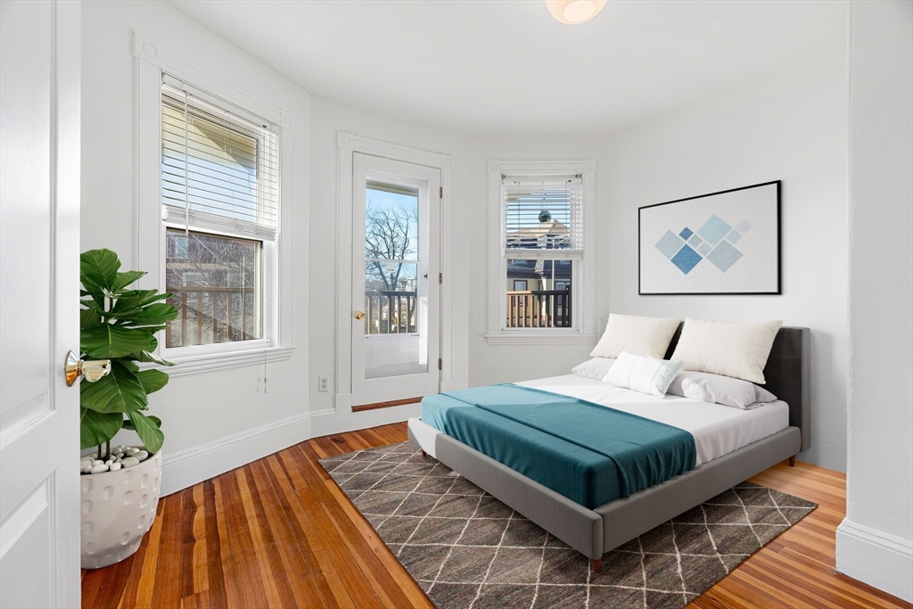 372 Adams Street, Unit 2 Boston, MA 02122 - Photo 7 of 20 a bedroom with a bed lamp and window