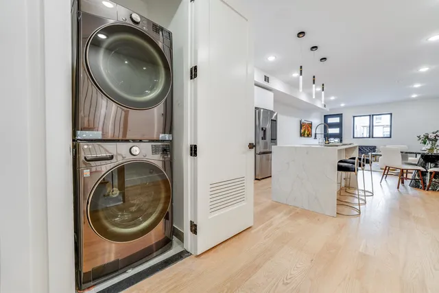 a view of a storage and utility room with washer and dryer