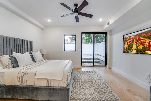 a spacious bedroom with a bed and a large window