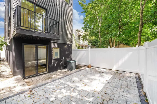 a view of a brick house with large windows
