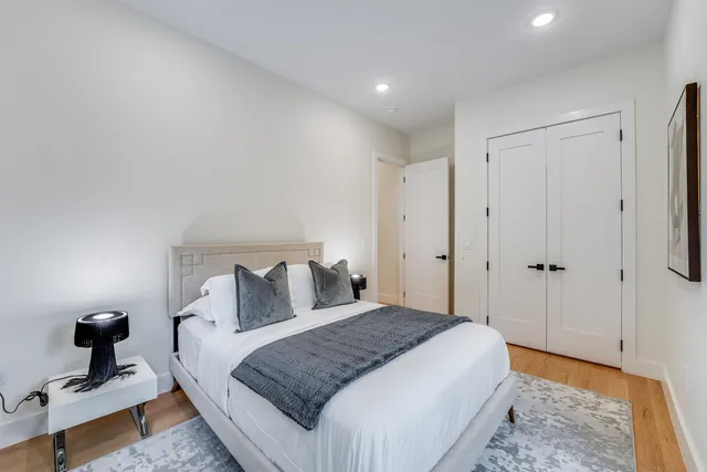 a bedroom with a bed and a lamp