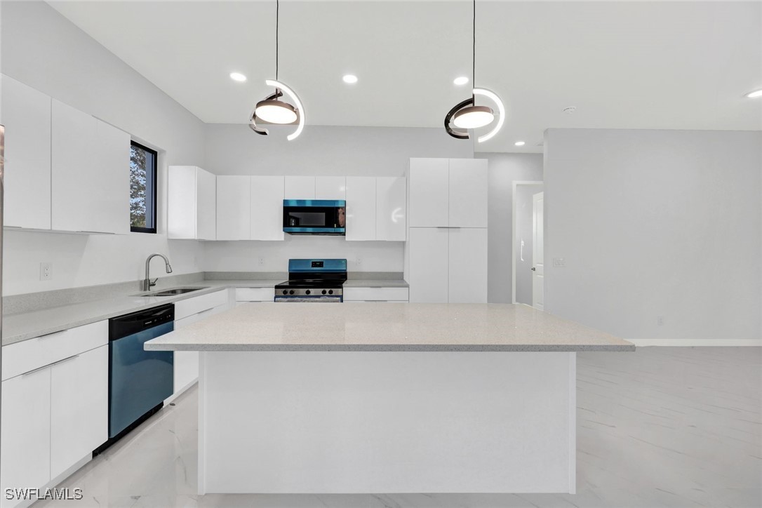 347 Ranch Avenue Lehigh Acres, FL 33974 - Photo 11 of 30 a kitchen with cabinets and appliances
