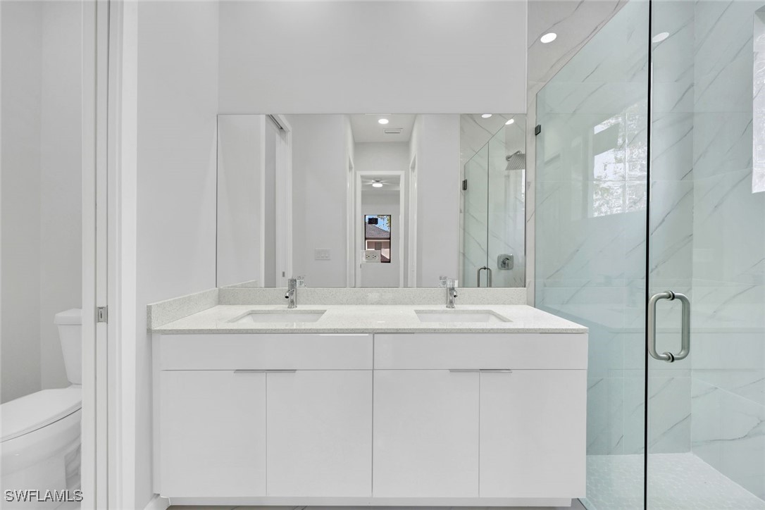 347 Ranch Avenue Lehigh Acres, FL 33974 - Photo 17 of 30 a bathroom with a double vanity sink mirror and double