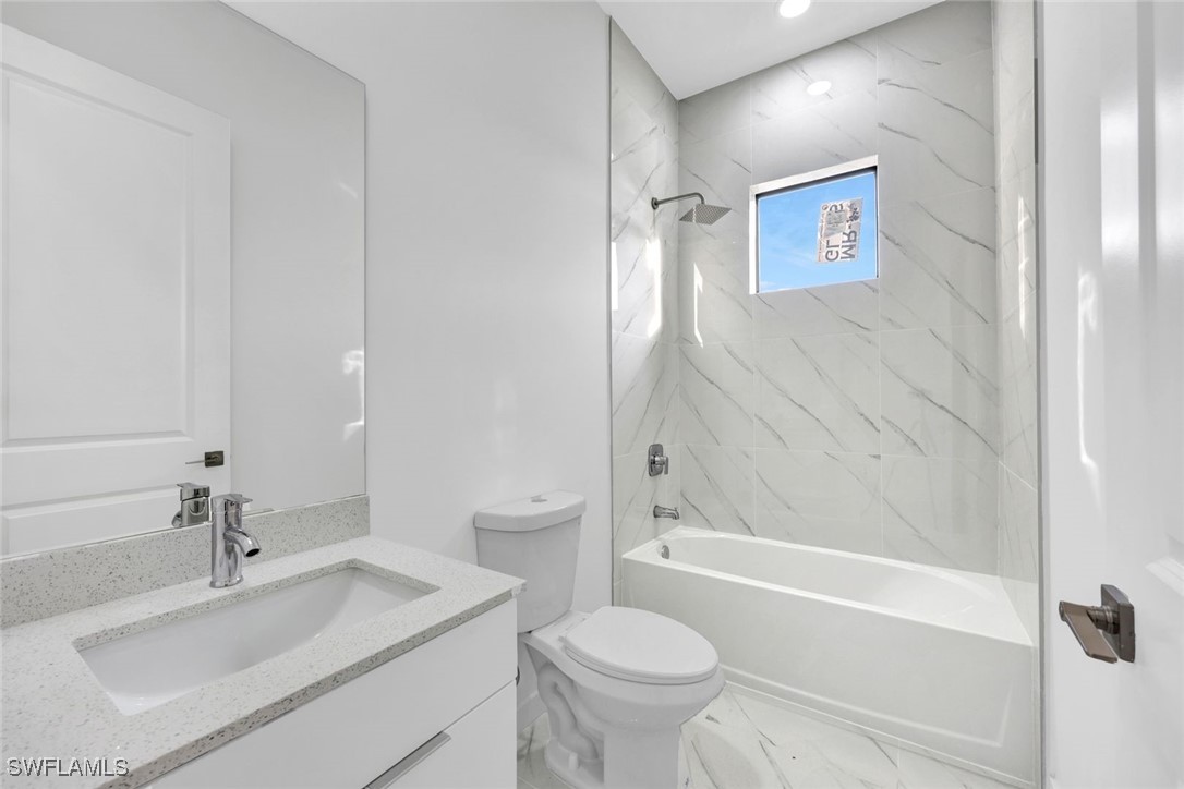 347 Ranch Avenue Lehigh Acres, FL 33974 - Photo 21 of 30 a bathroom with a sink toilet and shower