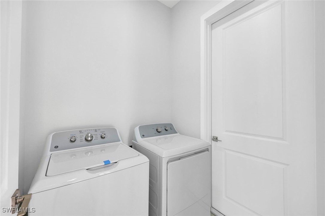347 Ranch Avenue Lehigh Acres, FL 33974 - Photo 23 of 30 a utility room with dryer and washer