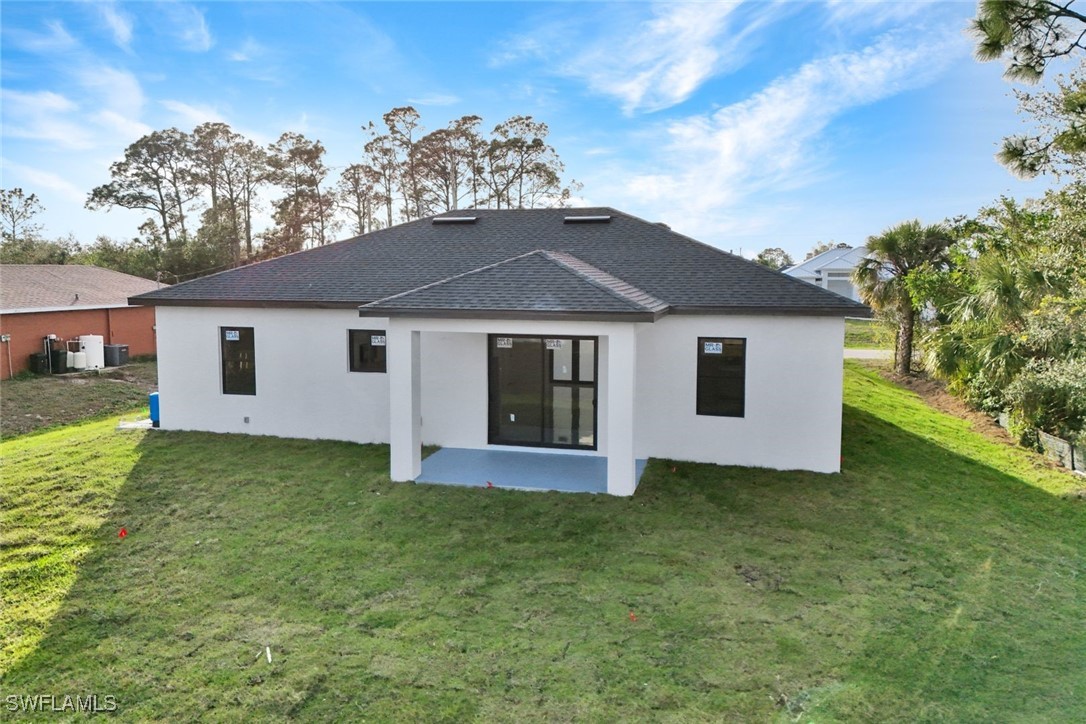 347 Ranch Avenue Lehigh Acres, FL 33974 - Photo 26 of 30 a front view of a house with garden