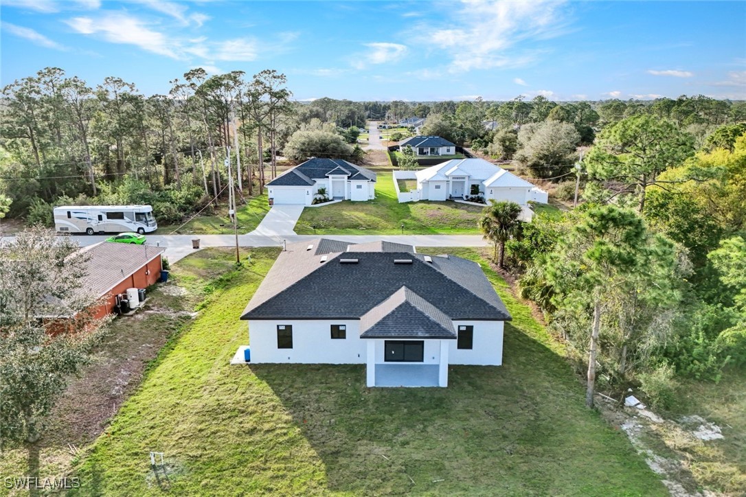 347 Ranch Avenue Lehigh Acres, FL 33974 - Photo 27 of 30 a aerial view of a house with a big yard and large trees