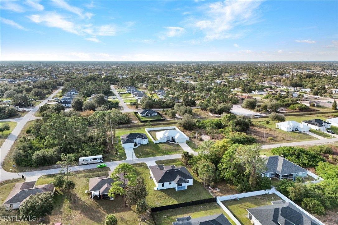 347 Ranch Avenue Lehigh Acres, FL 33974 - Photo 28 of 30 an aerial view of residential houses with yard