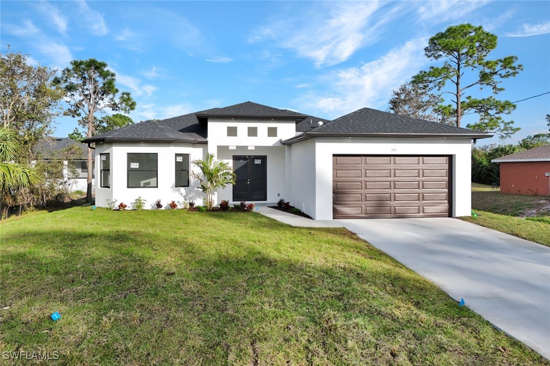 347 Ranch Avenue Lehigh Acres, FL 33974 - Photo 29 of 30 a front view of a house with garden