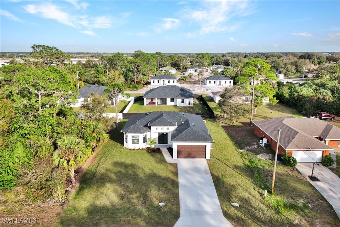 347 Ranch Avenue Lehigh Acres, FL 33974 - Photo 3 of 30 an aerial view of a house with a garden
