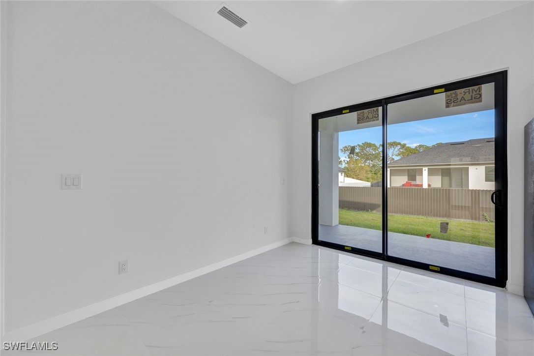 347 Ranch Avenue Lehigh Acres, FL 33974 - Photo 4 of 30 a view of empty room with floor to ceiling window