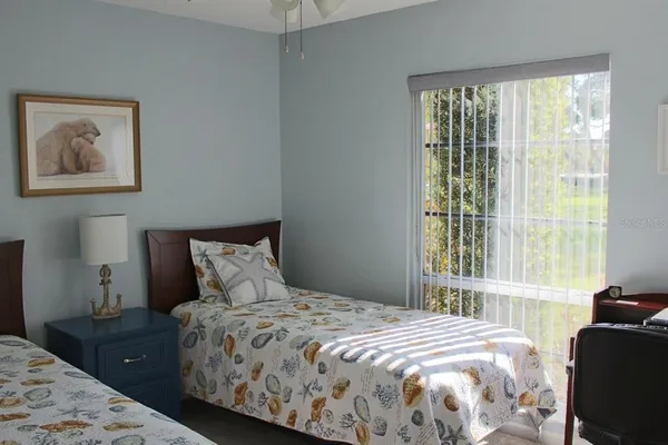 a bedroom with a bed and a large window