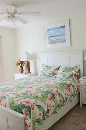 a bedroom with a bed and a painting on the wall