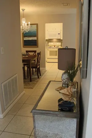 a room with gym equipment and stainless steel appliances
